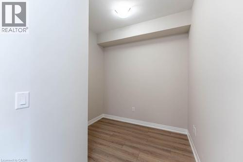 Unfurnished room featuring light wood finished floors and baseboards - 120 Springvalley Crescent Unit# 104, Hamilton, ON 