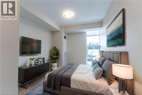 Bedroom featuring wood finished floors - 120 Springvalley Crescent Unit# 104, Hamilton, ON 