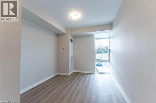 Unfurnished room featuring baseboards and light wood-type flooring - 120 Springvalley Crescent Unit# 104, Hamilton, ON 