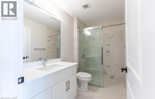 Full bath featuring light marble finish flooring, vanity, and a marble finish shower - 120 Springvalley Crescent Unit# 104, Hamilton, ON 