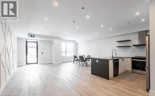 Kitchen with a peninsula, open shelves, open floor plan, stainless steel appliances, and recessed lighting - 120 Springvalley Crescent Unit# 104, Hamilton, ON 