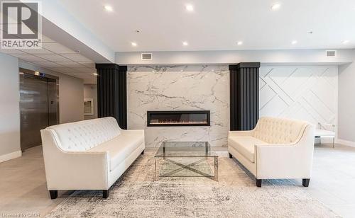 Living area with elevator and a premium fireplace - 120 Springvalley Crescent Unit# 104, Hamilton, ON 