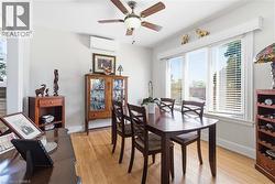 Dining area featuring light wood-finish flooring and a multi-pane window with blinds - 