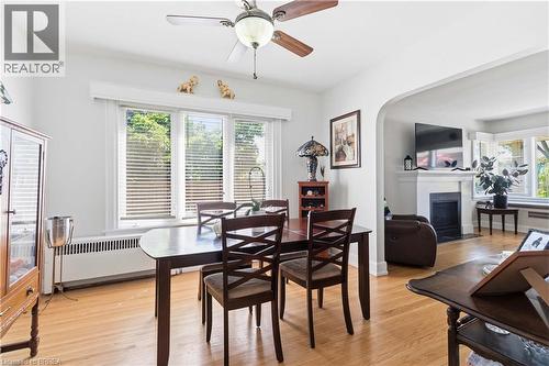 Dining space featuring wood-finish flooring, a ceiling fan, and a triple window with blinds - 134 Queensway Drive, Brantford, ON 