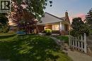Brick exterior with white siding accents and a covered front porch featuring white pillars - 134 Queensway Drive, Brantford, ON 