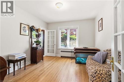 Room featuring wood-finish flooring, white painted walls, and recessed lighting - 134 Queensway Drive, Brantford, ON 