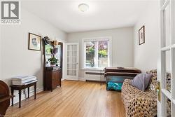 Room featuring wood-finish flooring, white painted walls, and recessed lighting - 