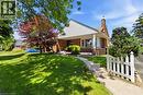Brick-front residence featuring white siding accents and a covered porch with pillars - 134 Queensway Drive, Brantford, ON 