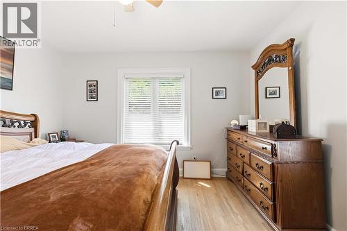 Hardwood flooring throughout featuring light-colored walls and a window with blinds - 134 Queensway Drive, Brantford, ON 
