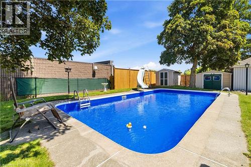 In-ground swimming pool with a concrete surround - 134 Queensway Drive, Brantford, ON 