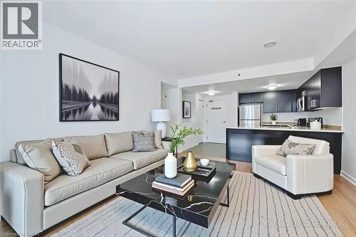 Open-concept living area with wood-finish flooring - 41 Goodwin Drive Unit# 202, Guelph, ON 