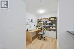 Dedicated office space featuring light wood-finish flooring - 