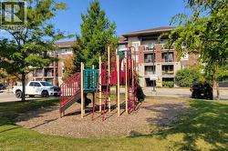 Outdoor playground equipment featuring multiple slides and climbing structures set on a wood chip base - 