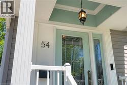 Front entrance featuring a transom window, sidelight, and leaded glass door - 