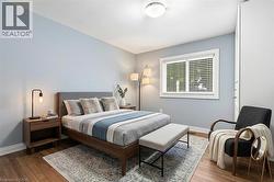 *VIRTUALLY STAGED* Hardwood-style flooring extends throughout this room, complemented by light blue wall tones - 