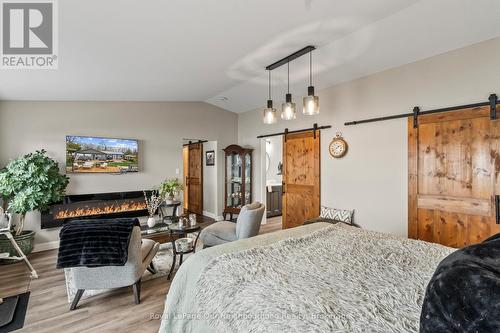 F - 1000 Garratt Road, Trent Hills, ON - Indoor Photo Showing Bedroom With Fireplace