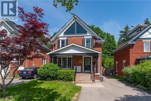 Brick exterior with a prominent front gable featuring an oversized triangular window - 40 Woodland Avenue, Kitchener, ON 