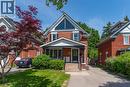Brick exterior with a prominent front gable featuring an oversized triangular window - 40 Woodland Avenue, Kitchener, ON 