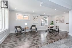 Open-concept living space with recessed lighting and wood-finish flooring - 