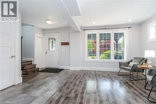 Kitchenette featuring white cabinetry, stainless steel appliances, wood-finish flooring, and recessed lighting - 40 Woodland Avenue, Kitchener, ON 