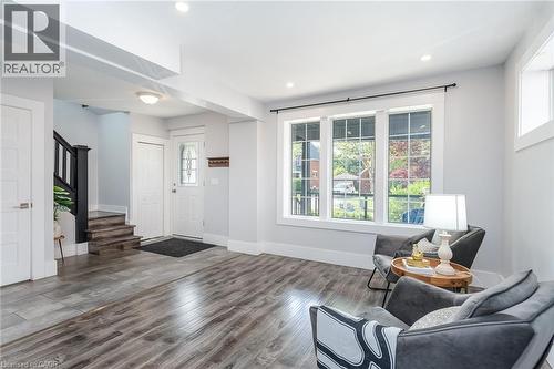 Open-concept living area with wood-finish flooring and recessed lighting - 40 Woodland Avenue, Kitchener, ON 