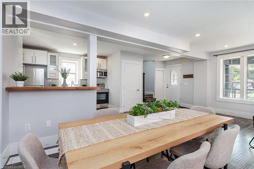 Contemporary bathroom featuring a spacious glass-enclosed shower with tiled walls and a white base, a gray vanity with an integrated white sink, a chrome faucet, and a wall-mounted medicine cabinet wi - 40 Woodland Avenue, Kitchener, ON 