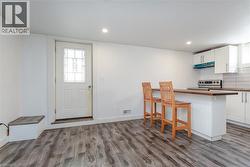 Open-concept living area with wood-finish flooring and recessed lighting - 