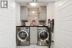 Dedicated laundry area featuring front-loading washer and dryer units - 