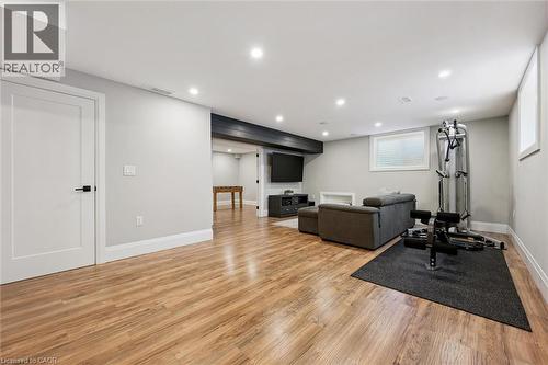 Open recreational space featuring wood-finish flooring, recessed lighting, and light gray wall paint - 72 Elmbank Trail, Kitchener, ON 