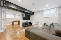 Recreation room featuring wood-finish flooring, recessed lighting, and a built-in media niche - 