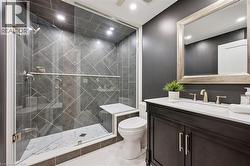 Contemporary bathroom featuring a dark vanity with a white countertop and rectangular sink - 
