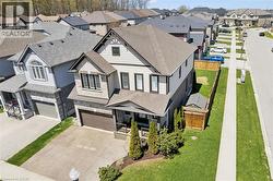 Two-story home featuring a stone and siding exterior with dark trim accents - 
