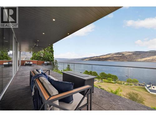 Constructed with stamped concrete for exceptional durability and low maintenance, the deck is finished with full stand-off glass railings to preserve unobstructed sight lines to Okanagan Lake. - 5835 Vicary Road, Peachland, BC 