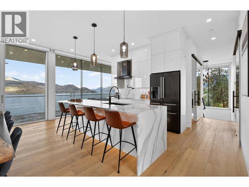 The chef-inspired kitchen features premium Cambria quartz waterfall countertops, a pot filler and an induction Wolf cooktop. - 5835 Vicary Road, Peachland, BC 