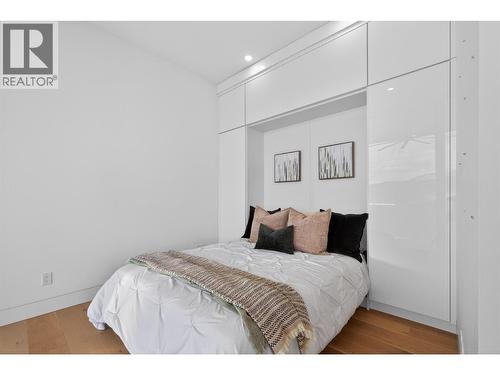 The secondary upstairs bedroom includes a built-in Murphy bed system, allowing the space to function beautifully as either a guest bedroom or a sophisticated home office. - 5835 Vicary Road, Peachland, BC 