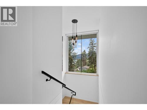 Oversized picture frame window in stairwell to maximize view and natural light (Of course with automated blinds too) - 5835 Vicary Road, Peachland, BC 