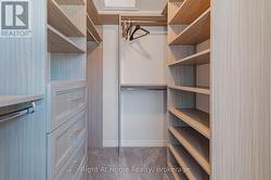 Large walk-in closet with custom built-in wardrobe - 