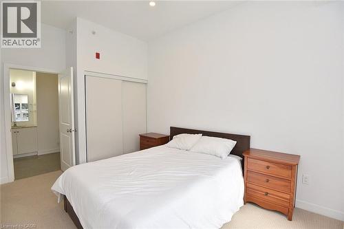 Carpeted interior room with white walls and a white sliding closet door - 4040 Upper Middle Road Unit# 105, Burlington, ON 