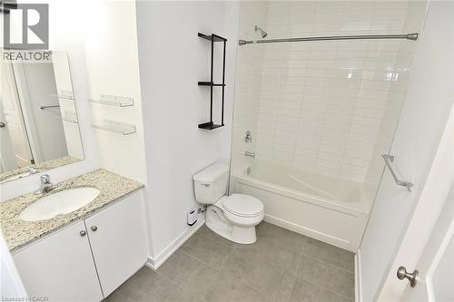 Contemporary bathroom featuring a white vanity with a light granite countertop, an oval undermount sink, and a large wall mirror - 4040 Upper Middle Road Unit# 105, Burlington, ON 