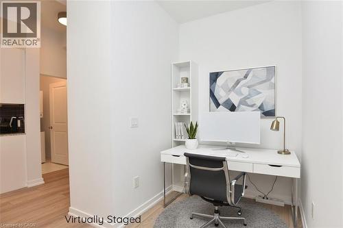 Dedicated office nook featuring a built-in shelving unit and light wood-finish flooring - 4040 Upper Middle Road Unit# 105, Burlington, ON 