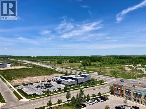 Expansive urban landscape featuring commercial structures, paved roadways, and undeveloped green spaces - 4878 Powers Common Unit# C-1105, Burlington, ON 