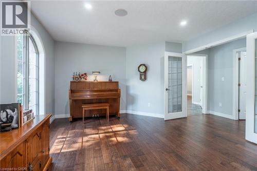 Living area featuring baseboards, french doors, and dark wood finished floors - 18 Westie Road, Brantford, ON 
