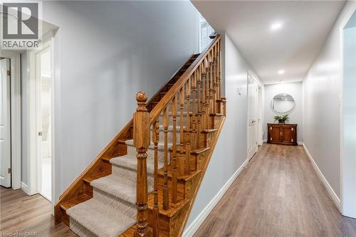 Stairway featuring baseboards and wood finished floors - 18 Westie Road, Brantford, ON 