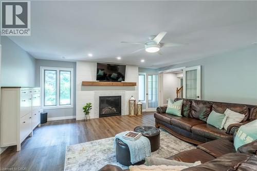 Living area featuring recessed lighting, baseboards, a large fireplace, ceiling fan, and wood finished floors - 18 Westie Road, Brantford, ON 