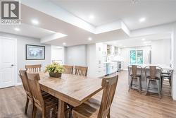 Dining area featuring baseboards, light wood-style floors, and recessed lighting - 