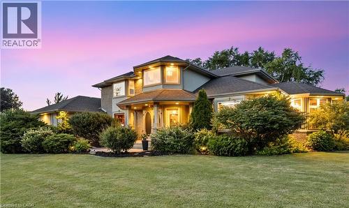 Stucco exterior with multiple gables and a covered entry - 7775 St. Augustine Crescent, Niagara Falls, ON 