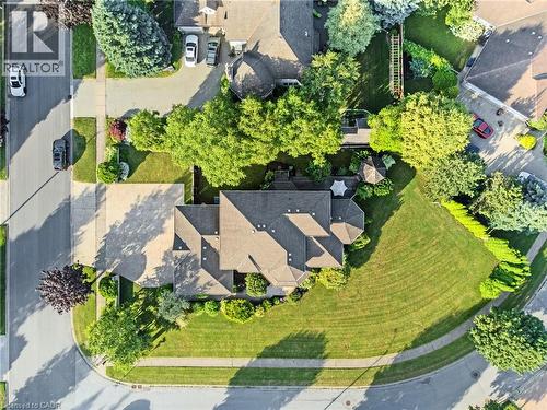 Spacious corner lot featuring a multi-gabled roofline, concrete driveway, and established perimeter trees - 7775 St. Augustine Crescent, Niagara Falls, ON 
