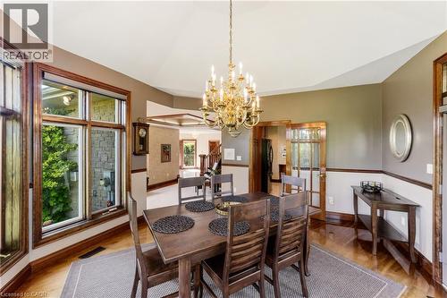 Dining area featuring a gold-finish chandelier and wood-finish flooring, wrap around windows for lots of natural light - 7775 St. Augustine Crescent, Niagara Falls, ON 
