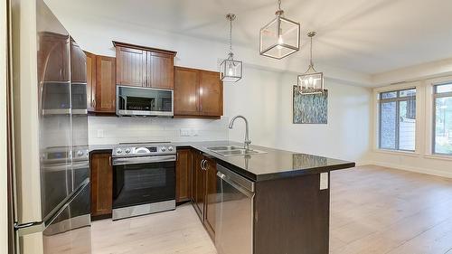 102-3533 Carrington Road, West Kelowna, BC - Indoor Photo Showing Kitchen With Stainless Steel Kitchen With Double Sink