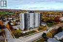 High-rise residential building featuring a two-tone facade, private balconies, and a surface parking lot - 2055 Upper Middle Road Unit# 602, Burlington, ON 